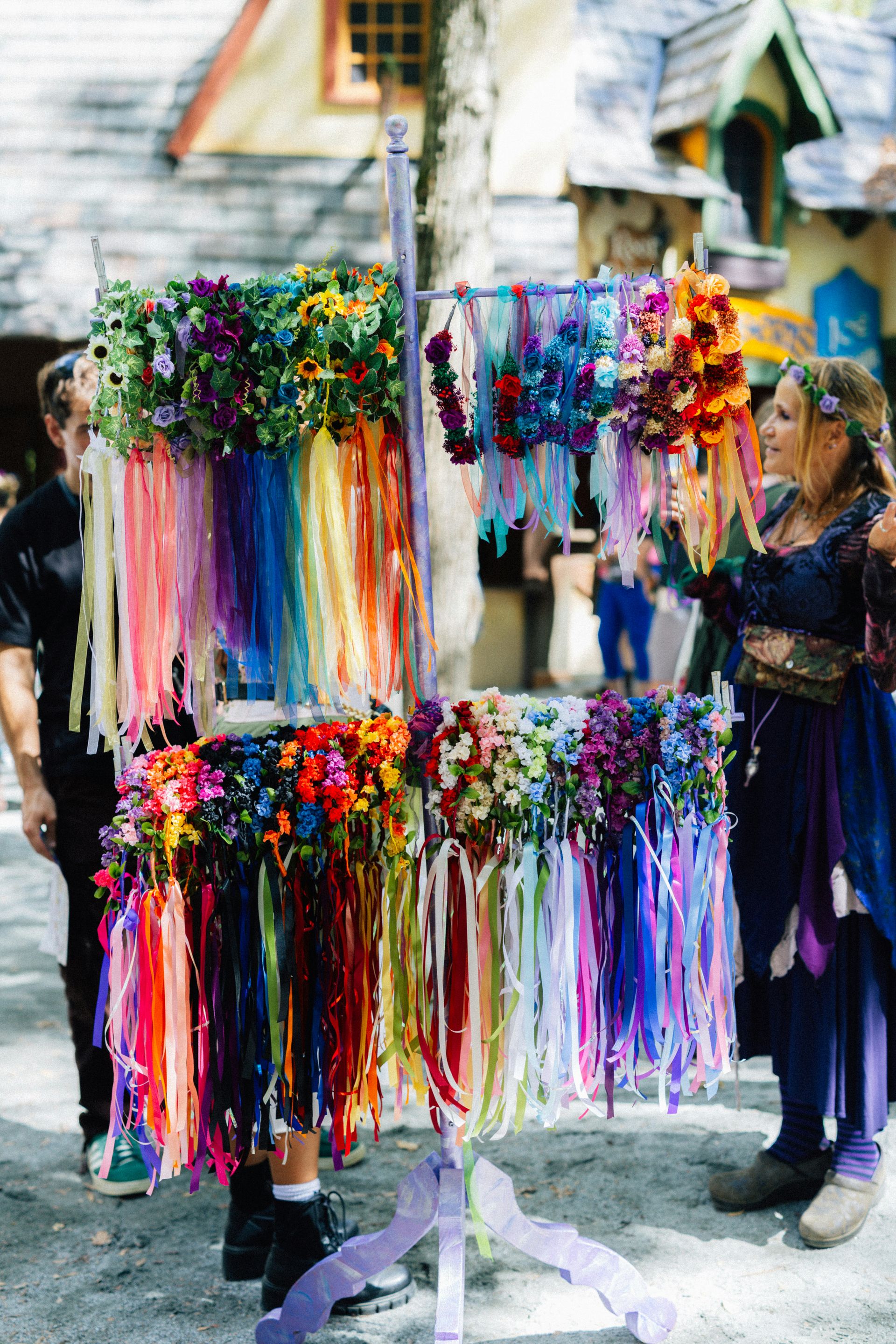 Colorful flower crown vendor stall at a Renaissance Festival